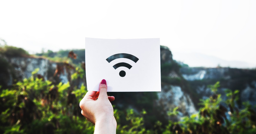 Image showing a female hand holding up a wifi symbol drawn on paper. Image showing a female hand holding up a wifi symbol drawn on paper.