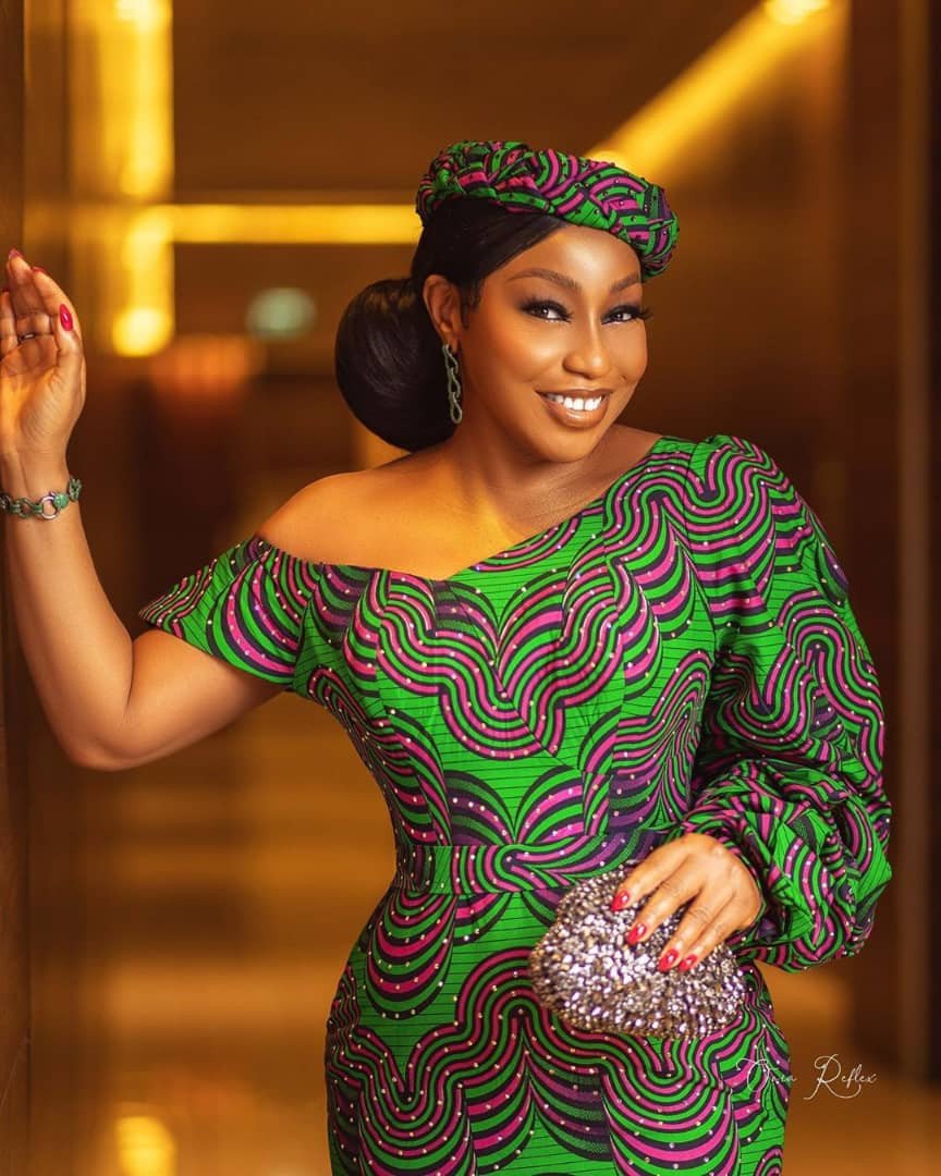 Rita Dominic, a vision in green and purple
