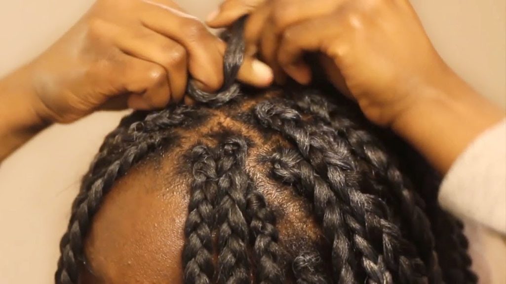 Beginner's Guide On How To Plait Your Hair 1 Plaiting herself (photo credit Seun Okimi)