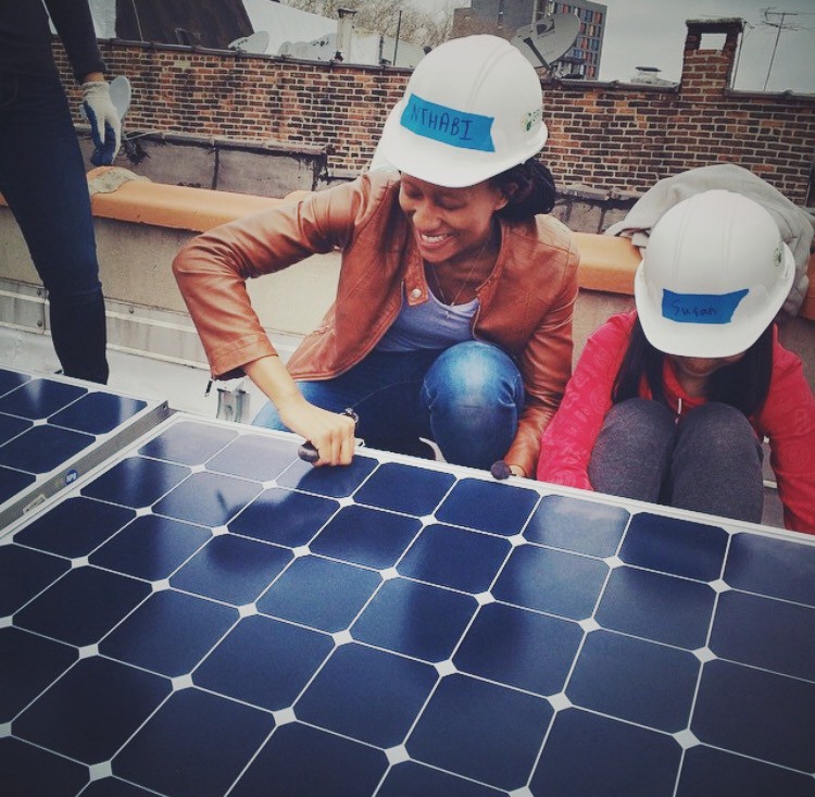 Nthabiseng Mosia tightening a bolt on a solar panel (Photo credit: Medium)
