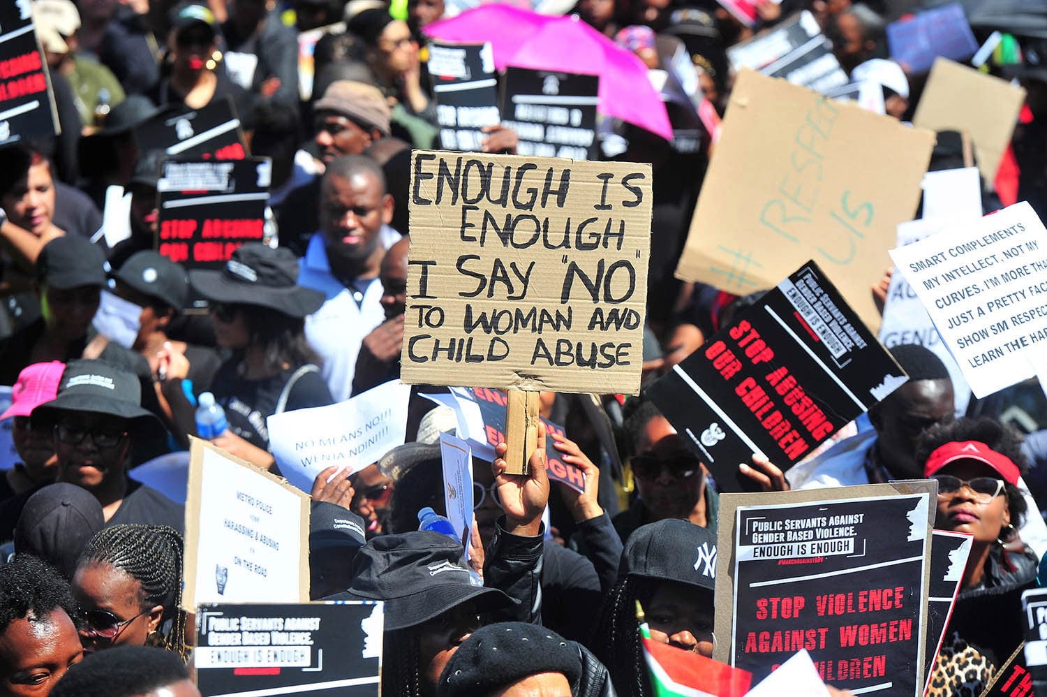 People with diverse placards in a women's rights protest in Africa
