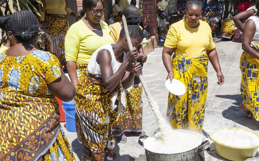 Bride's family preparing food for Chilanga Mulilo ceremony which is one of the important bridal traditions in Zambia